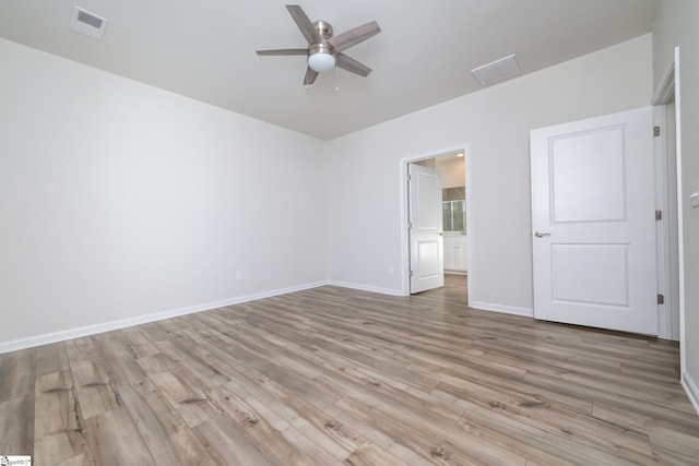 empty room with ceiling fan and light wood-type flooring