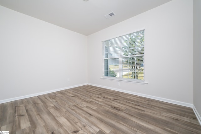 spare room with hardwood / wood-style floors