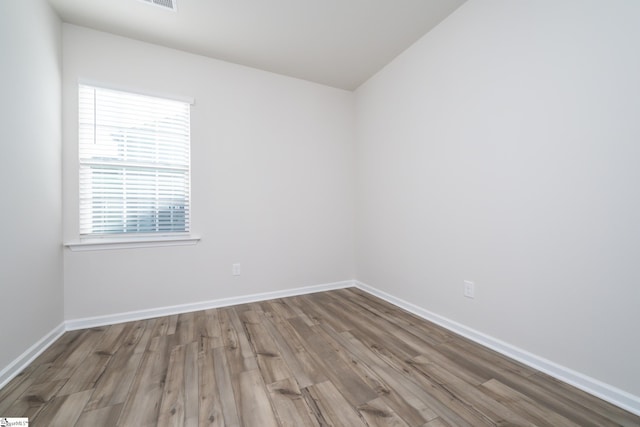 spare room featuring wood-type flooring