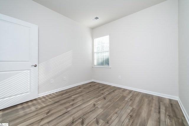 unfurnished room with hardwood / wood-style flooring