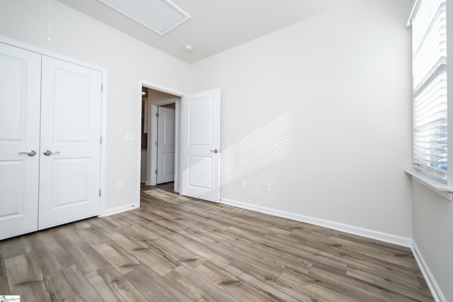 unfurnished bedroom featuring a closet and light wood-type flooring