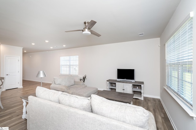 living room with ceiling fan and dark hardwood / wood-style floors