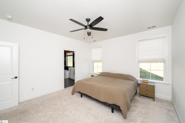 bedroom with light colored carpet, multiple windows, and ceiling fan