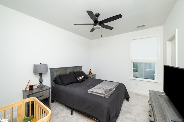 bedroom featuring ceiling fan and light colored carpet