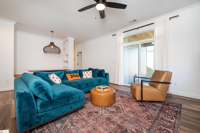 living room featuring wood-type flooring, ceiling fan, and ornamental molding