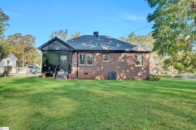 rear view of house featuring a yard and cooling unit