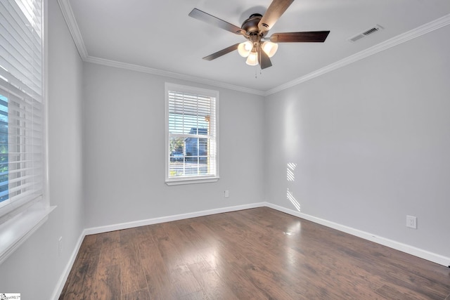 empty room with ceiling fan, dark hardwood / wood-style flooring, and ornamental molding