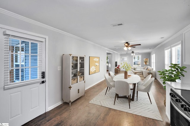 dining area featuring dark hardwood / wood-style floors, ceiling fan, and crown molding