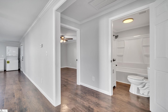 hallway with dark wood-type flooring and ornamental molding