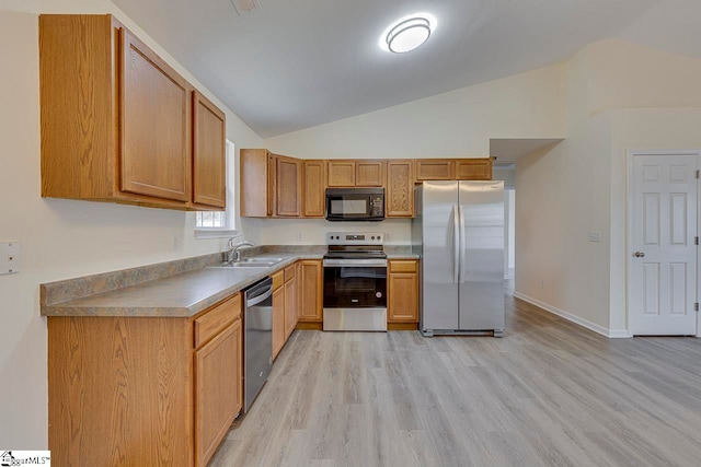 kitchen with sink, light wood-type flooring, lofted ceiling, and stainless steel appliances