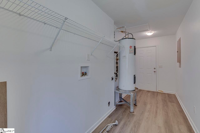 laundry room with light hardwood / wood-style floors, hookup for a washing machine, and water heater