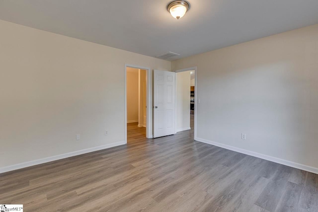 spare room with hardwood / wood-style flooring