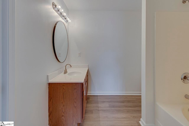 bathroom with hardwood / wood-style flooring and vanity