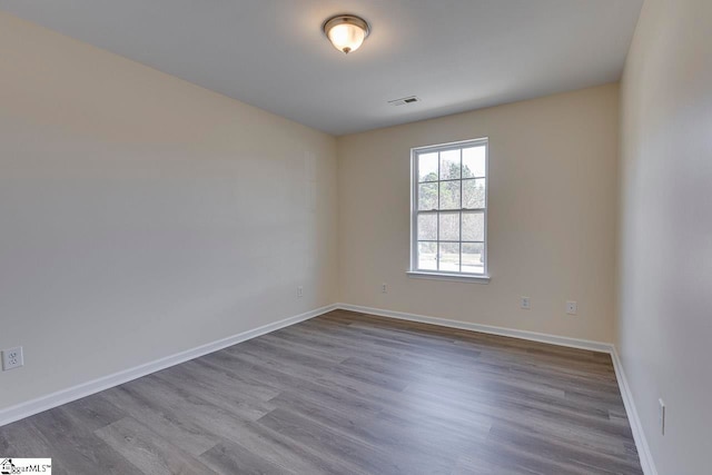 unfurnished room with hardwood / wood-style flooring