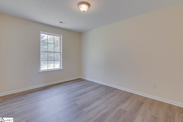 spare room with light hardwood / wood-style floors