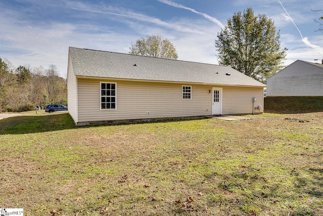 back of house featuring a lawn