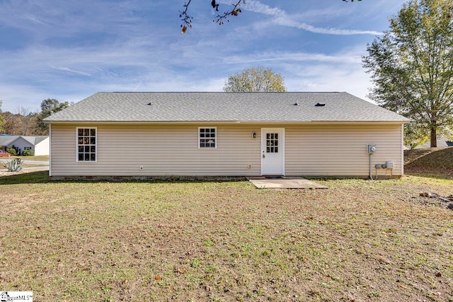 rear view of house with a yard