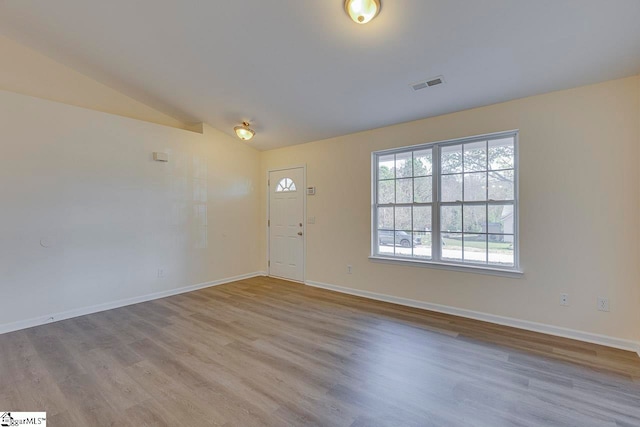 foyer featuring lofted ceiling and light wood-type flooring