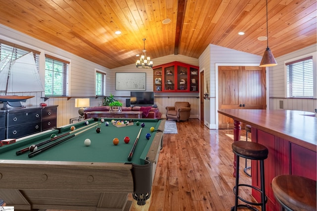 recreation room with light hardwood / wood-style floors, vaulted ceiling, wooden ceiling, and wood walls