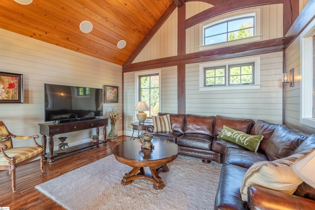 living room with hardwood / wood-style floors, wood walls, wood ceiling, and high vaulted ceiling