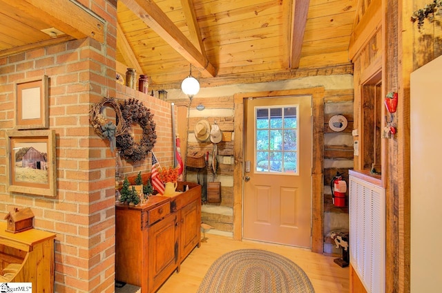 entryway featuring lofted ceiling with beams, light hardwood / wood-style floors, and wooden ceiling