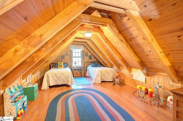 bedroom featuring hardwood / wood-style flooring, vaulted ceiling, wooden ceiling, and wood walls