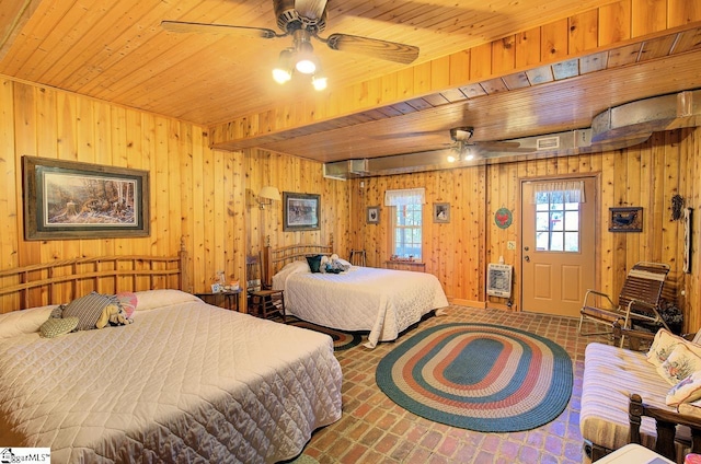 bedroom featuring wood ceiling, wooden walls, and heating unit