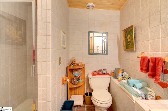 bathroom with toilet, tile walls, and walk in shower