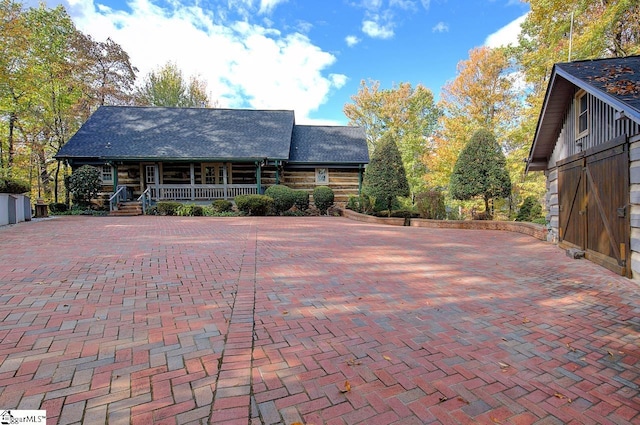 log cabin featuring a porch