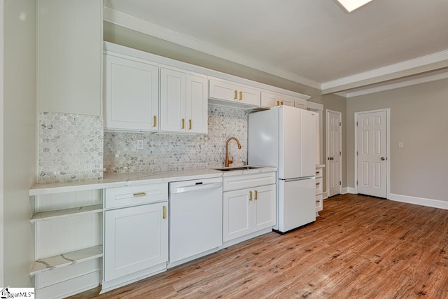 kitchen featuring white cabinetry, sink, light hardwood / wood-style floors, and white appliances