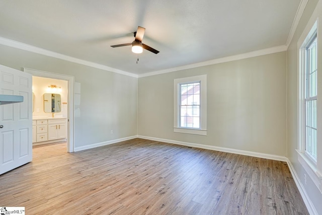 interior space with ceiling fan, light hardwood / wood-style floors, ornamental molding, and ensuite bathroom