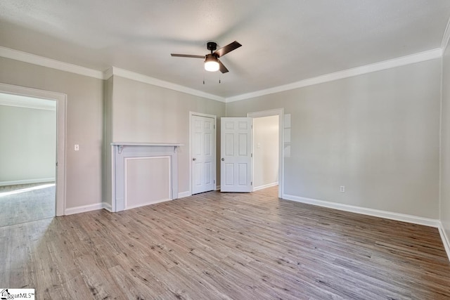 empty room featuring ceiling fan, ornamental molding, and light wood-type flooring