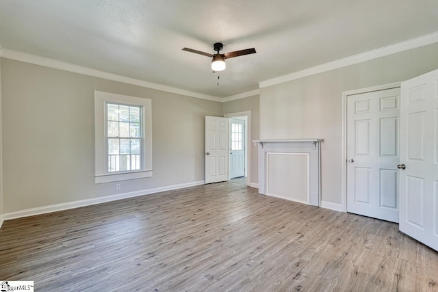 unfurnished living room with a textured ceiling, ceiling fan, light wood-type flooring, and ornamental molding