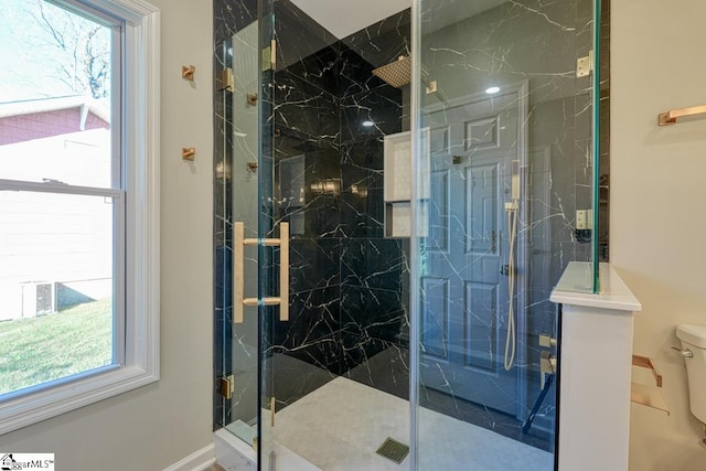 bathroom featuring toilet and an enclosed shower