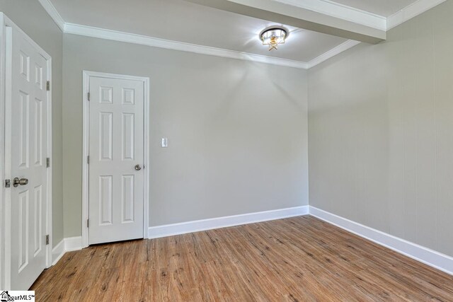 unfurnished room featuring crown molding and light hardwood / wood-style flooring