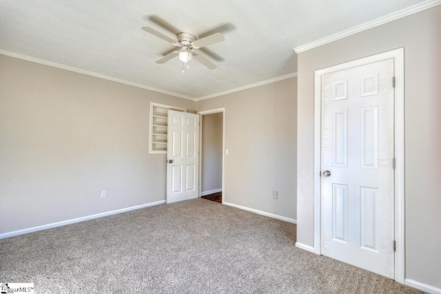 unfurnished bedroom with ceiling fan, carpet floors, a textured ceiling, and ornamental molding