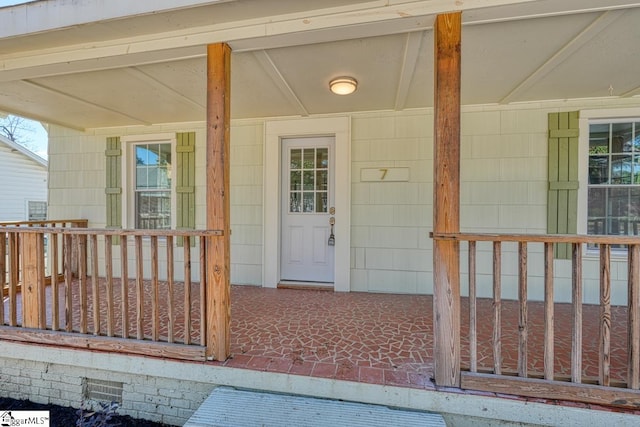 view of exterior entry with covered porch