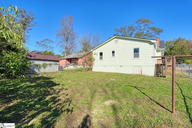 back of house featuring a yard