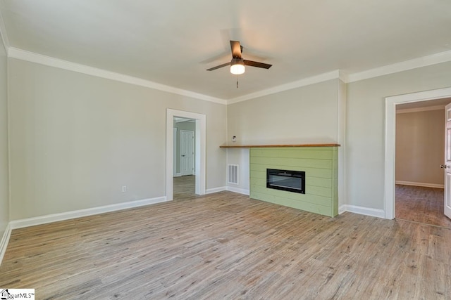 unfurnished living room with ceiling fan, crown molding, and light hardwood / wood-style flooring