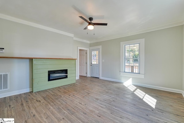 unfurnished living room with crown molding, ceiling fan, and light hardwood / wood-style floors