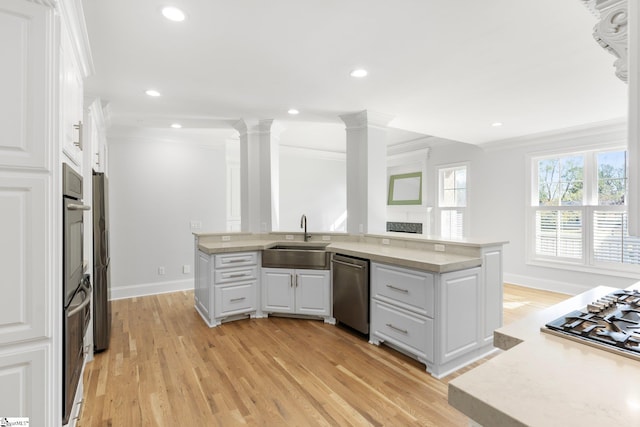 kitchen featuring light hardwood / wood-style floors, white cabinetry, sink, and stainless steel appliances