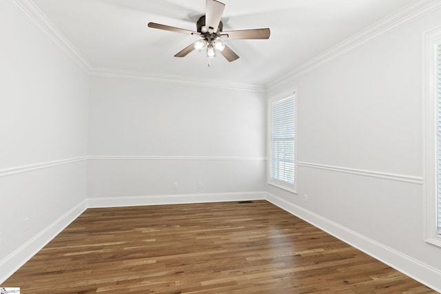 empty room with dark hardwood / wood-style floors, ceiling fan, and crown molding