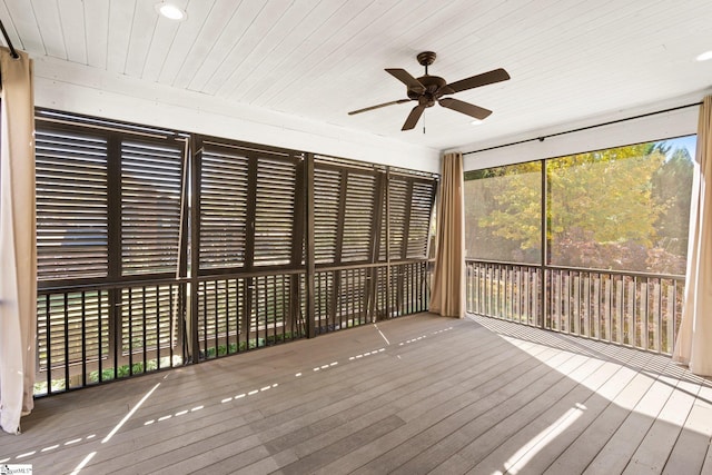 unfurnished sunroom featuring ceiling fan and wood ceiling