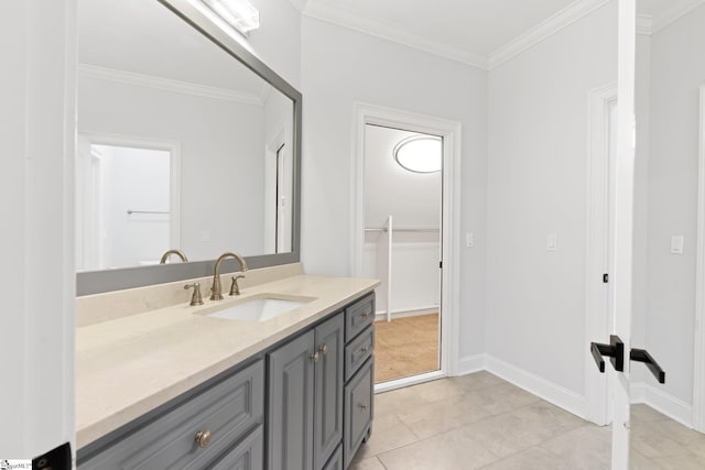 bathroom with tile patterned flooring, vanity, and ornamental molding