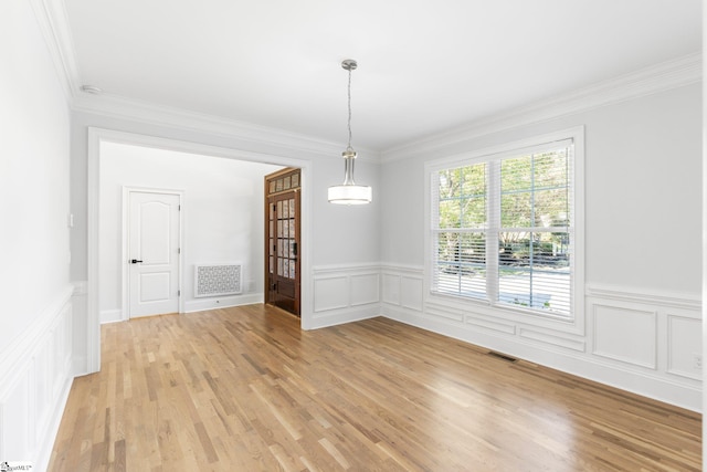 spare room with crown molding and light hardwood / wood-style flooring