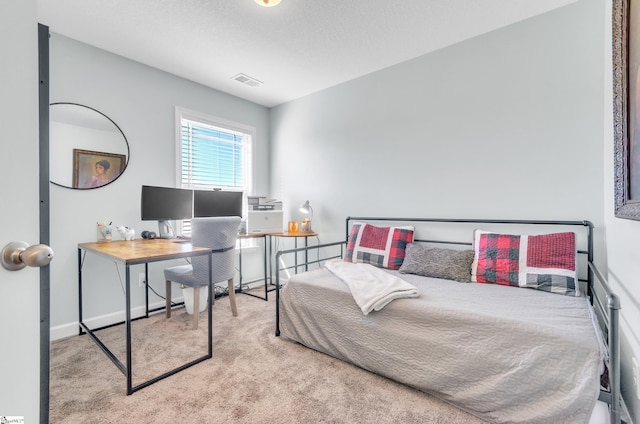 bedroom with light colored carpet