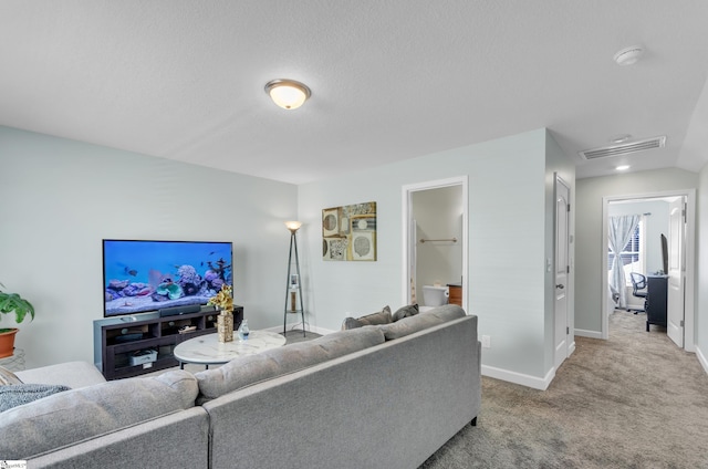 living room with light colored carpet and a textured ceiling