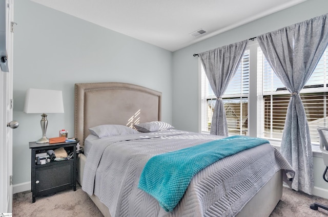 bedroom featuring light carpet