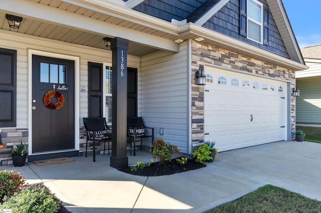 entrance to property featuring a garage and covered porch