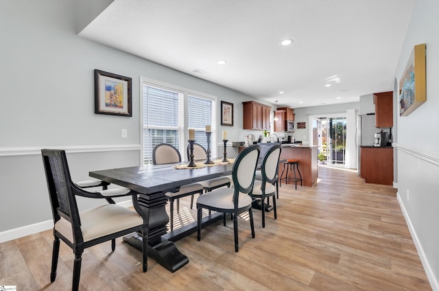 dining area featuring light wood-type flooring